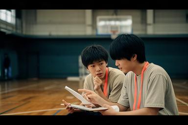 松阪の学校体育館で取材内容を確認する高校生と大学生の学生記者